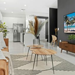 a living room filled with furniture and a flat screen tv