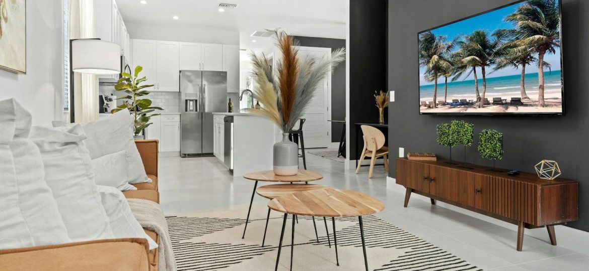 a living room filled with furniture and a flat screen tv