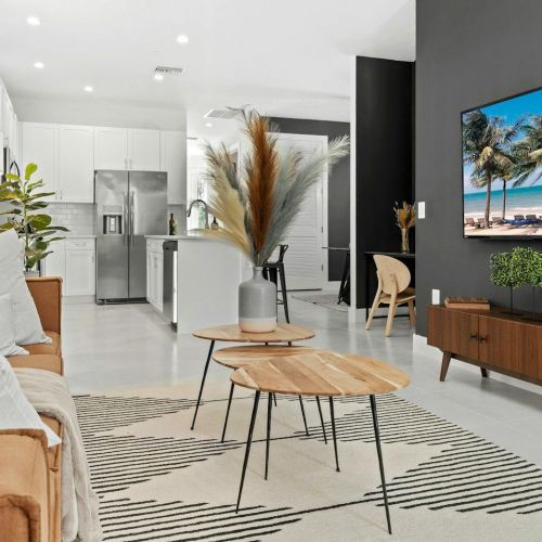 a living room filled with furniture and a flat screen tv