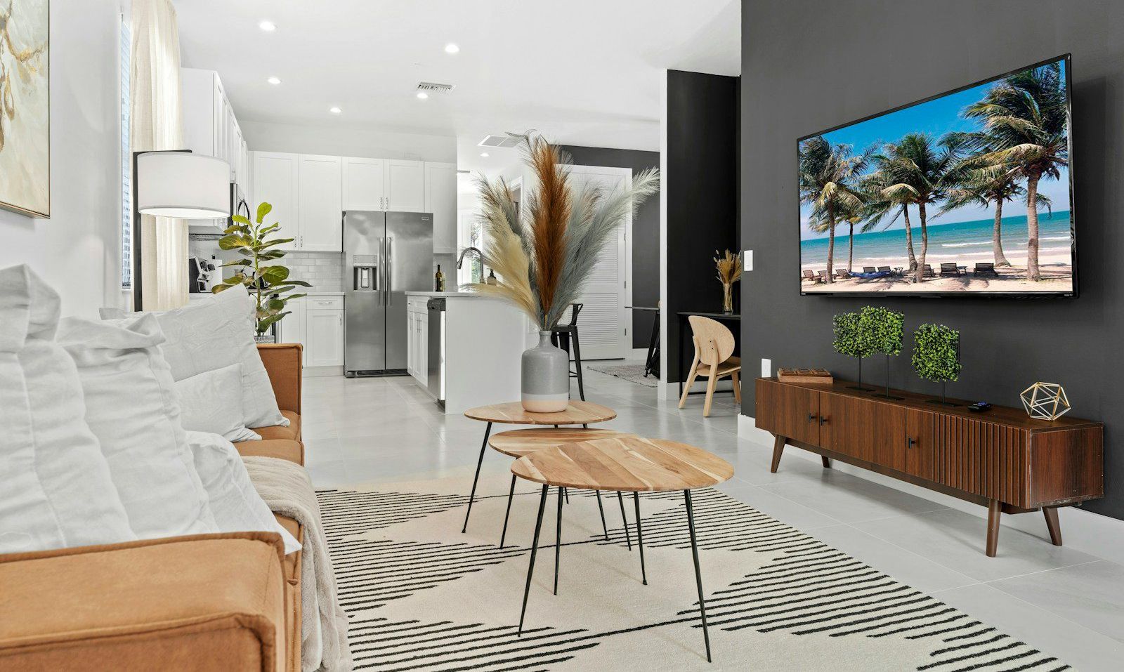 a living room filled with furniture and a flat screen tv