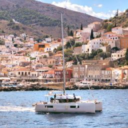 white boat on sea near city buildings during daytime
