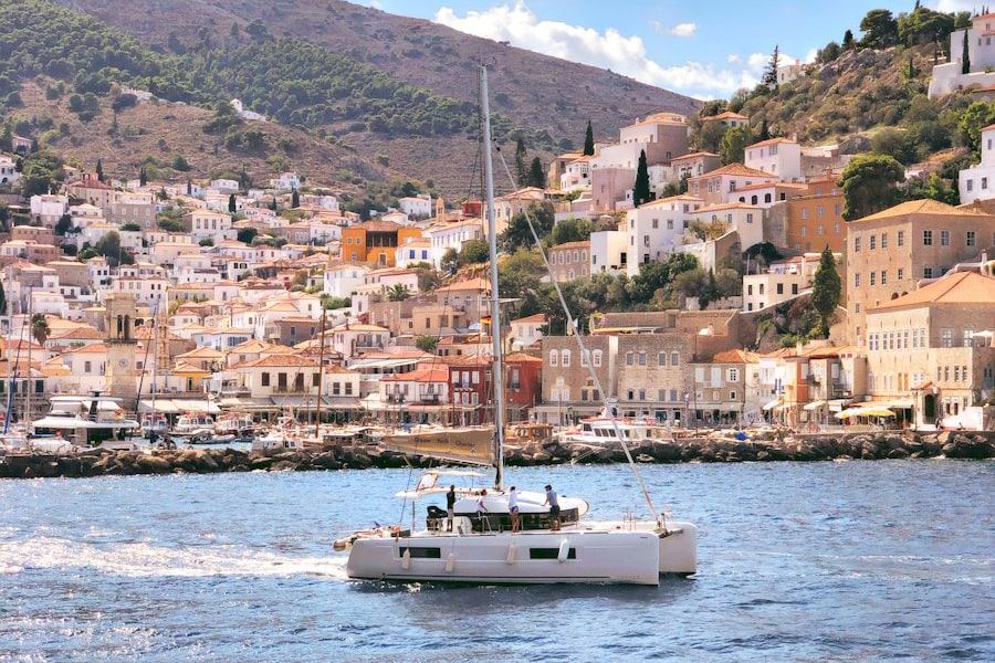 white boat on sea near city buildings during daytime